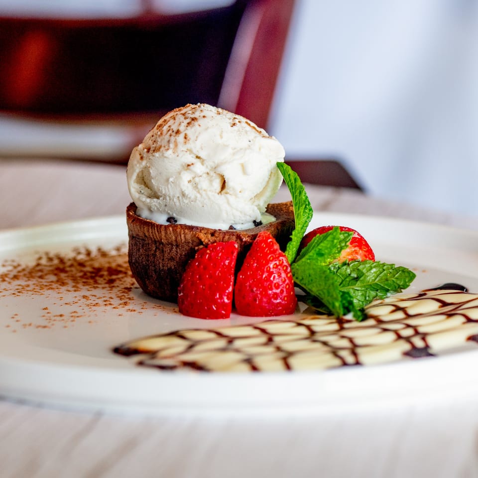 Tartufo Restaurant's chocolate lava cake with vanilla ice cream, strawberries, and mint.